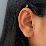 Gold sun charm vertical helix (bugadi) earring in sterling silver with a dangling CZ stone.